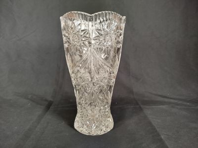 a glass vase that is sitting on a black background