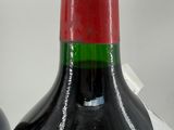 two bottles of wine sitting next to each other on a table