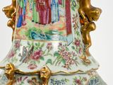 a vase with a painting on it sitting on a table