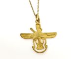 a close up of a gold necklace with a bird on it