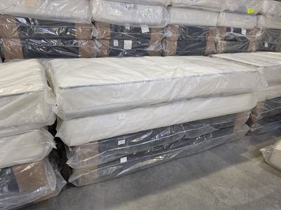 many boxes of mattresses stacked on top of each other