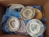 many plates in a box that are sitting in the box