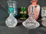 several glass vases are lined up on a black background