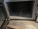a microwave with a door open on a table