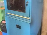 a blue cabinet with a glass door in a room