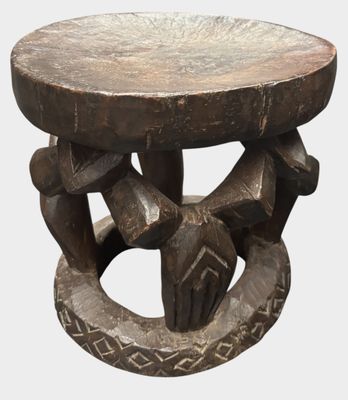 a wooden table with a carved design on top of it