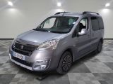 the silver van is parked on a checkered floor in a room
