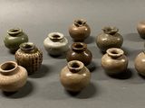 a lot of small vases that are sitting on a table