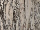a close up of a marble table with a clock on it