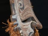 an image of a wooden mask on a black background