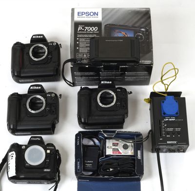 many different cameras that are sitting on a table