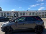 a grey suv parked in front of a building