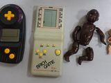 a toy of a baby sitting next to a game controller