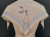 a close up of a mannequin torso with a white and blue scarf on it