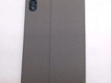 the back of a gray ipad case sitting on top of a white table