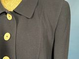 a woman ' s gray jacket with yellow buttons on a mannequin mannequin mannequin mannequin mannequin mannequin mannequin