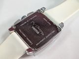a close up of a watch on a white surface