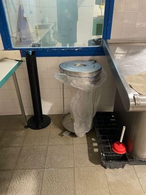 a trash can and a trash can in a public restroom