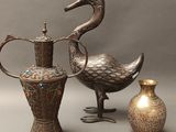 three vases and a bird on a gray background
