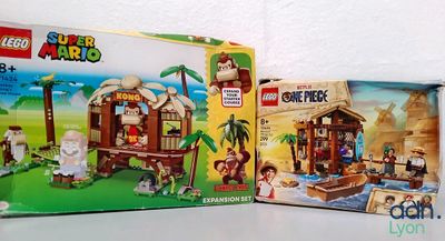 two boxes of lego super marios and a box of legos on a table