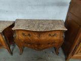 pair of marble topped bedside tables in the shape of a chest of drawers