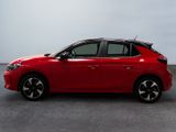 a red car is parked in a room with a white wall