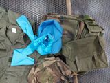 a pile of military clothing on a metal surface