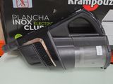 a black and silver vacuum on a table next to a box of krampozzi