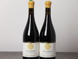 two bottles of wine sitting on top of a wooden table