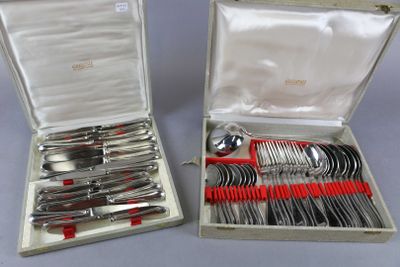 two sets of silverware in a case on a table