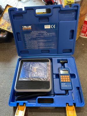 a blue tool box with tools in it on the floor