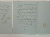 an old document with writing on it sitting on top of a table
