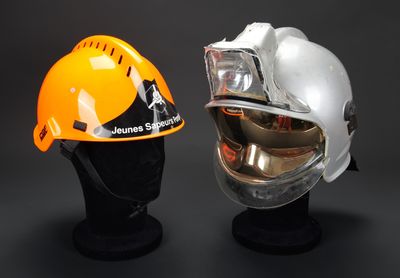une paire de casques de sécurité exposée sur un fond noir
