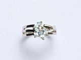 a close up of a diamond ring on a white surface
