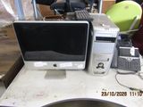 a desk with a computer and a cell phone on it