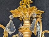 a gold chandelier with crystal drops hanging from it