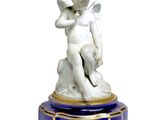 a statue of an angel sitting on top of a table