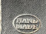a close up of a black leather wallet with a logo on it