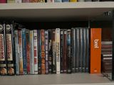 a book shelf with many dvds on it