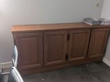 a desk with a chair and a cabinet in the corner