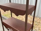 a metal shelf that has three shelves on top of it