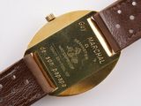 a close up of a watch on a white surface