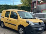 yellow van parked in a parking lot next to other cars