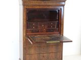 a wooden cabinet with a marble top on a white floor