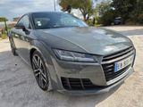 the audi ttr is parked on the side of the road in a parking lot