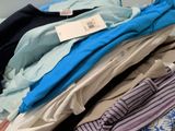 a lot of clothes that are stacked on top of each other