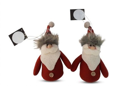 deux pères Noël en peluche qui se tiennent l'un à côté de l'autre