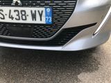 a close up of a silver car with a number plate on it