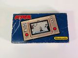 a small electronic game on a white surface