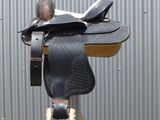 a horse saddle that is on a metal pole